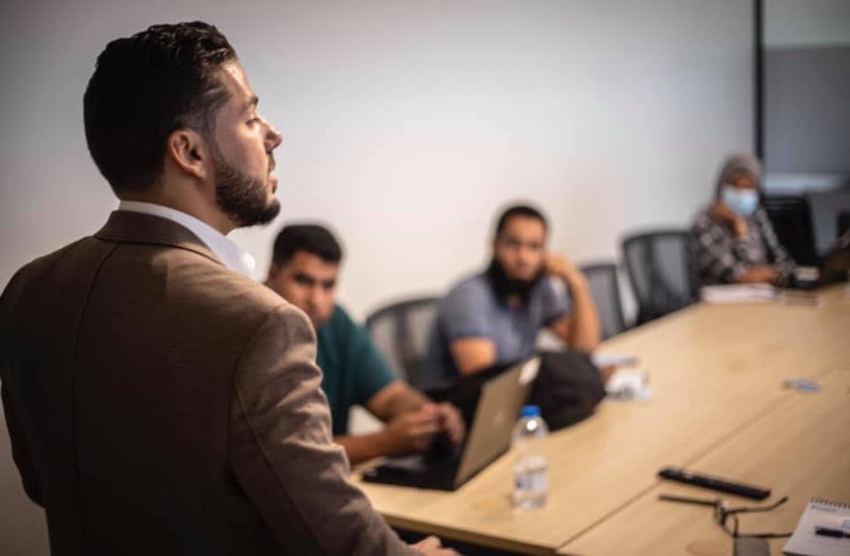 Taha K. Sultan presenting to a small group in a meeting room