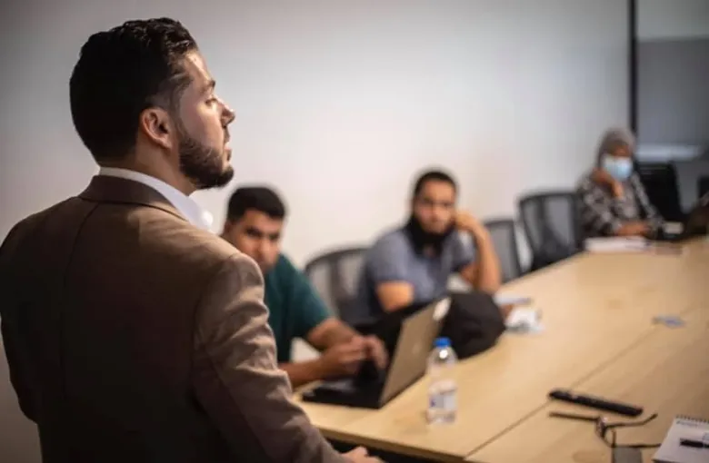 Taha K. Sultan presenting to a small group in a meeting room