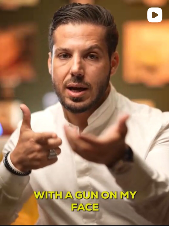 Video still captioned "With a gun on my face"